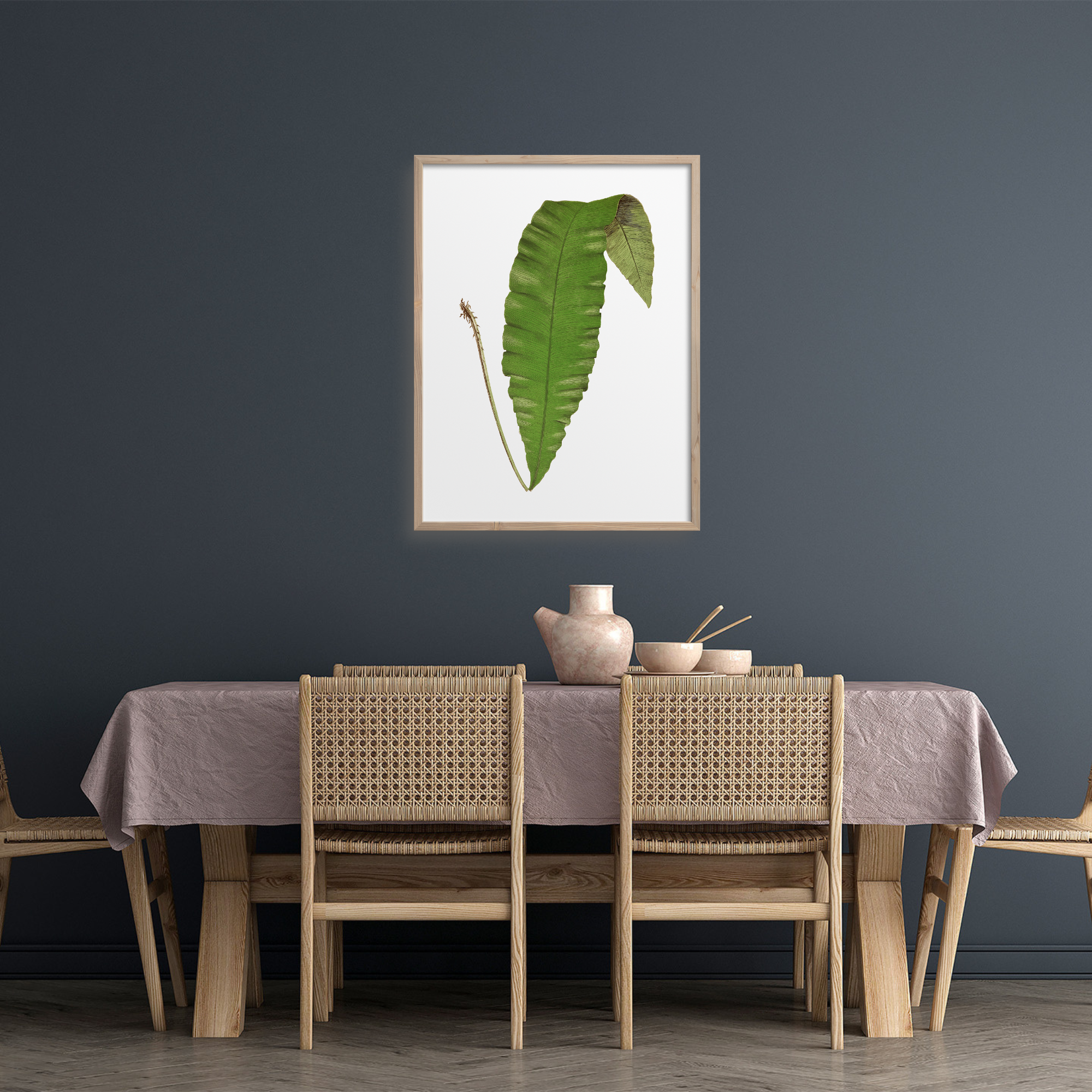 Single green fern leaf in a dining room.