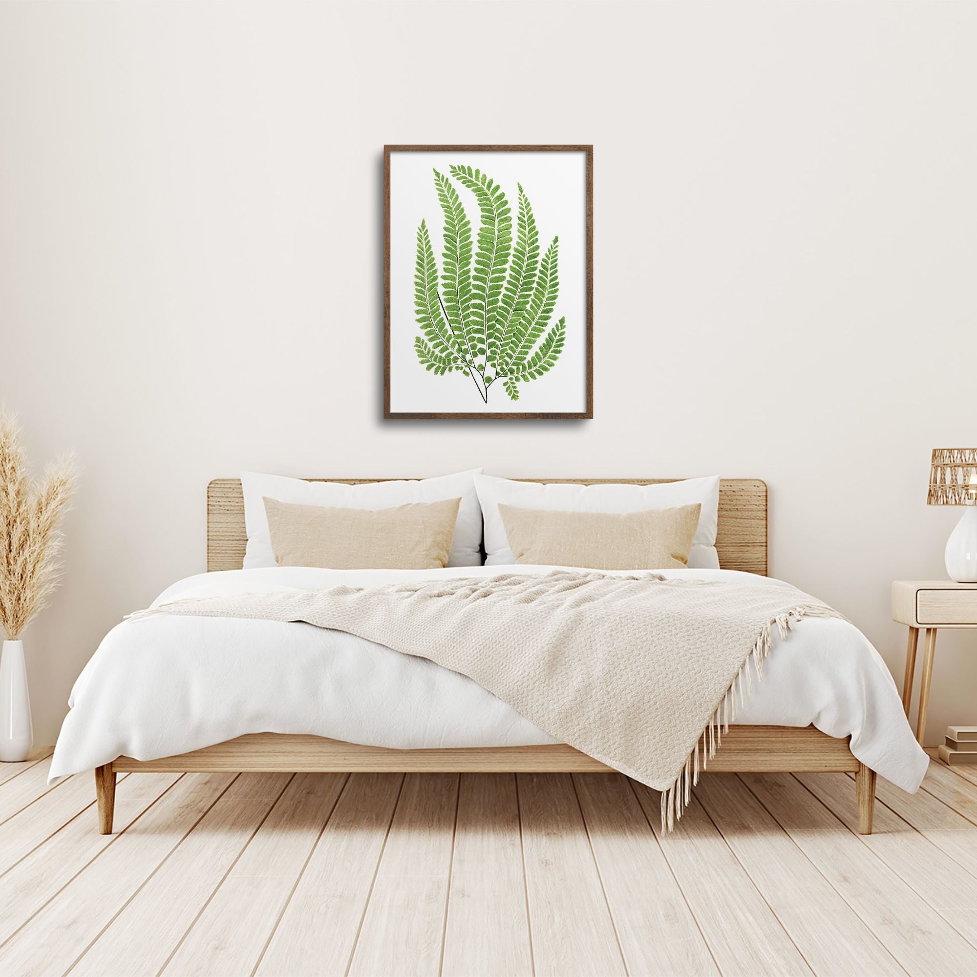 Framed fern over a bed.