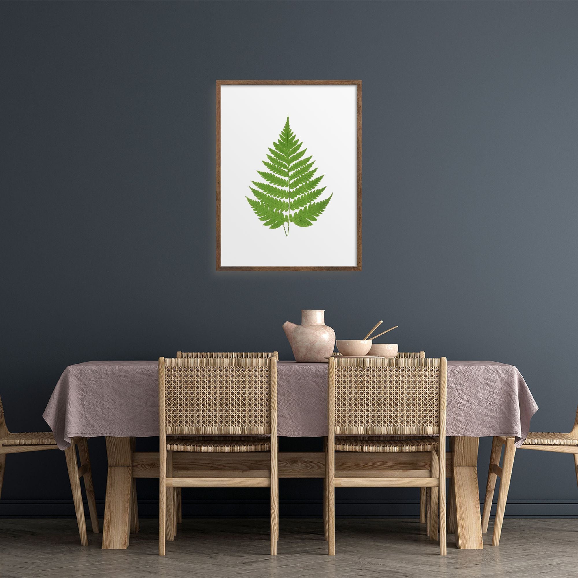 Single fern art print in a dining room.