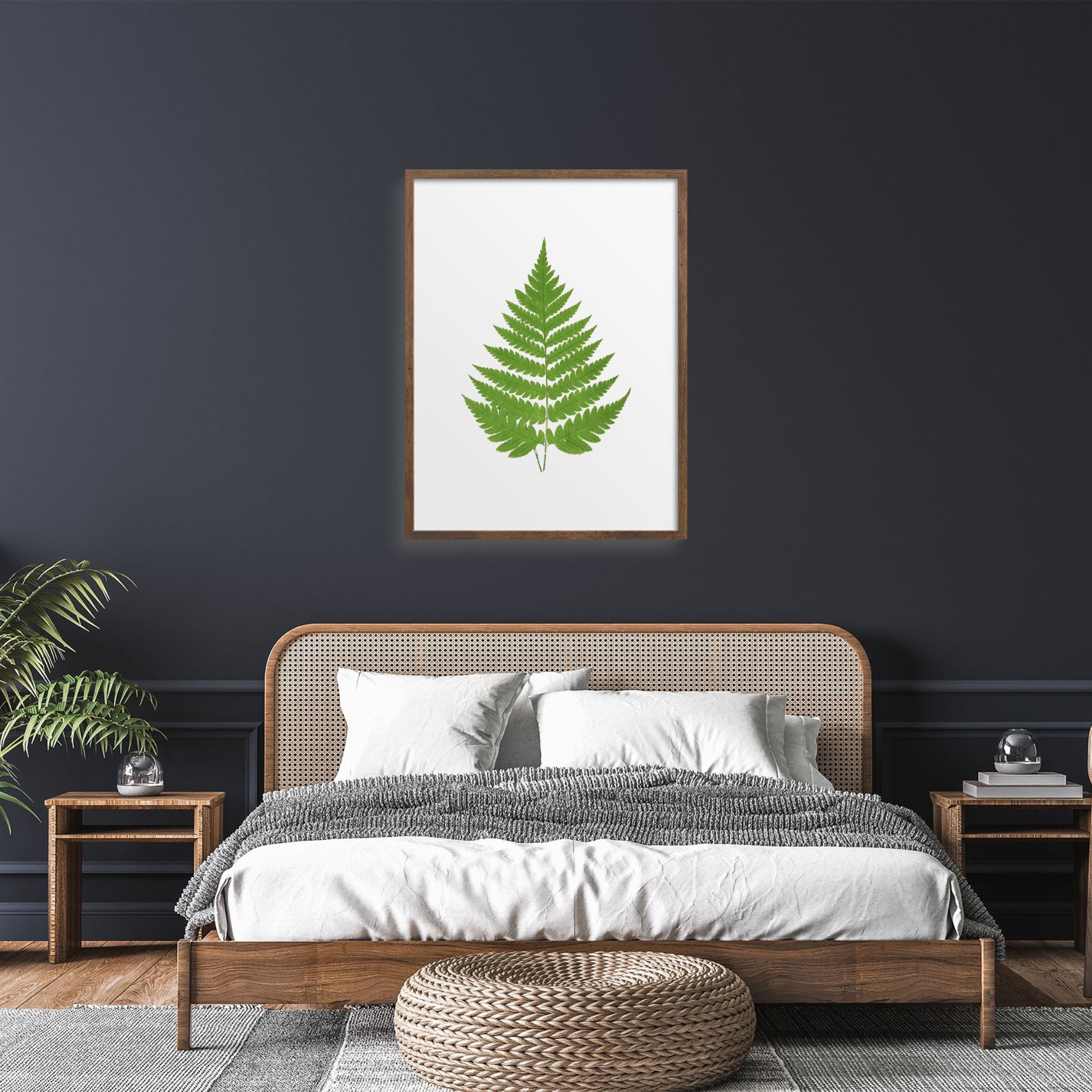 Simple green fern art print on a dark wall.
