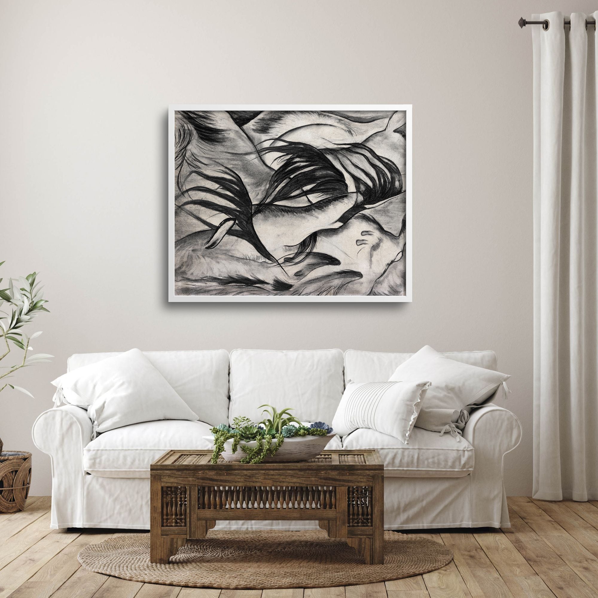Abstract goats artwork over couch in a minimalist living room.