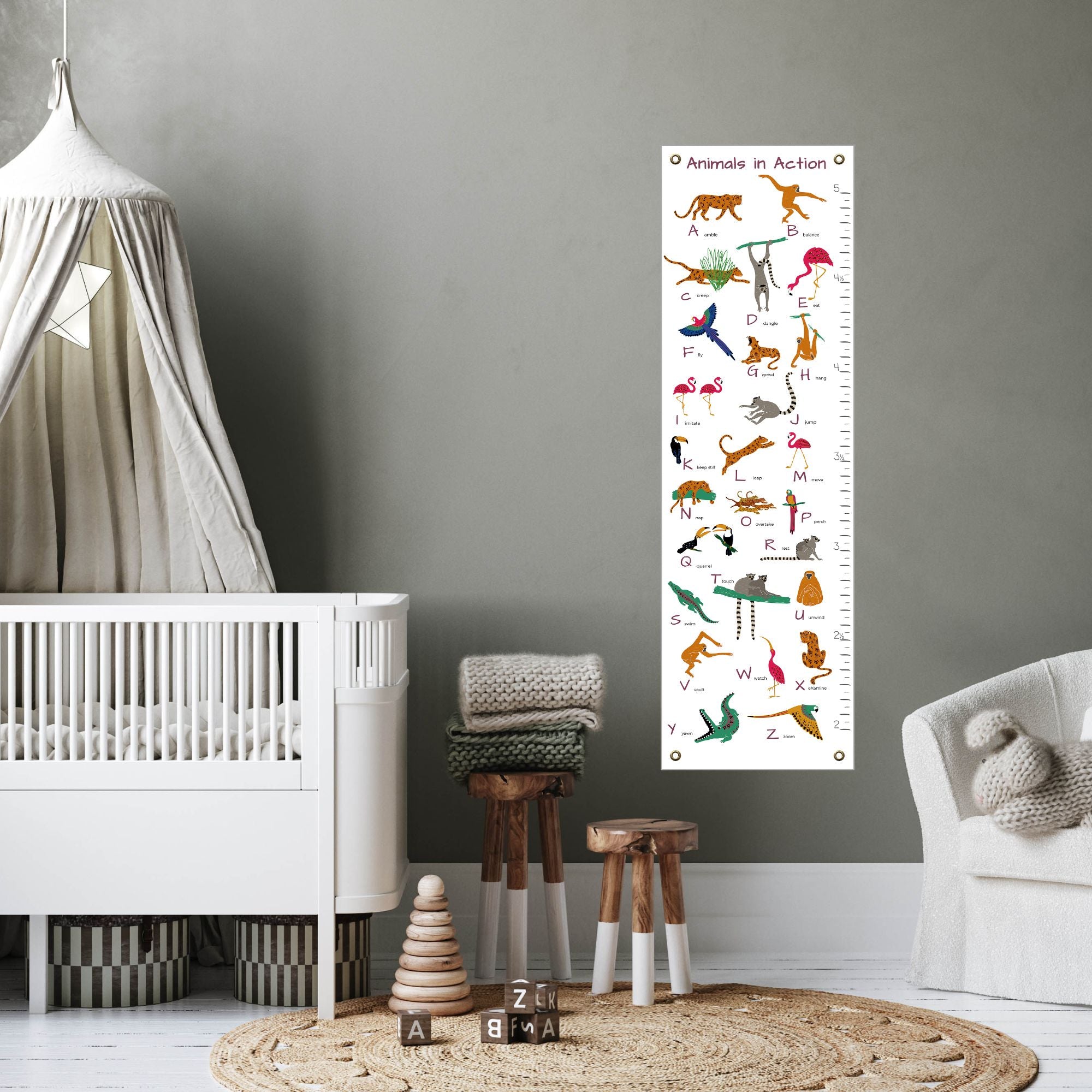 Animal alphabet height chart in child's nursery next to a crib
