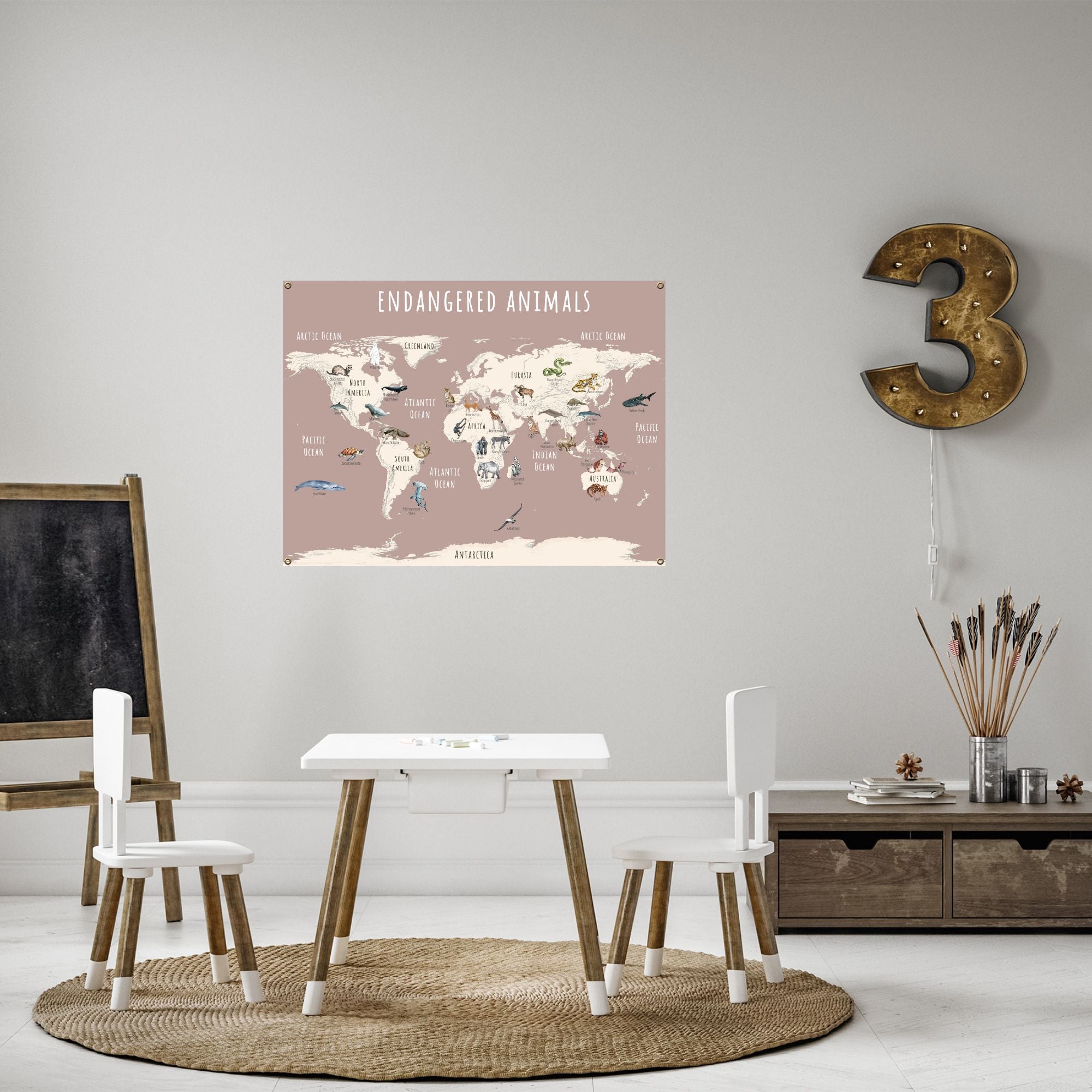 Endangered animals world map in pink hanging in a child's playroom.