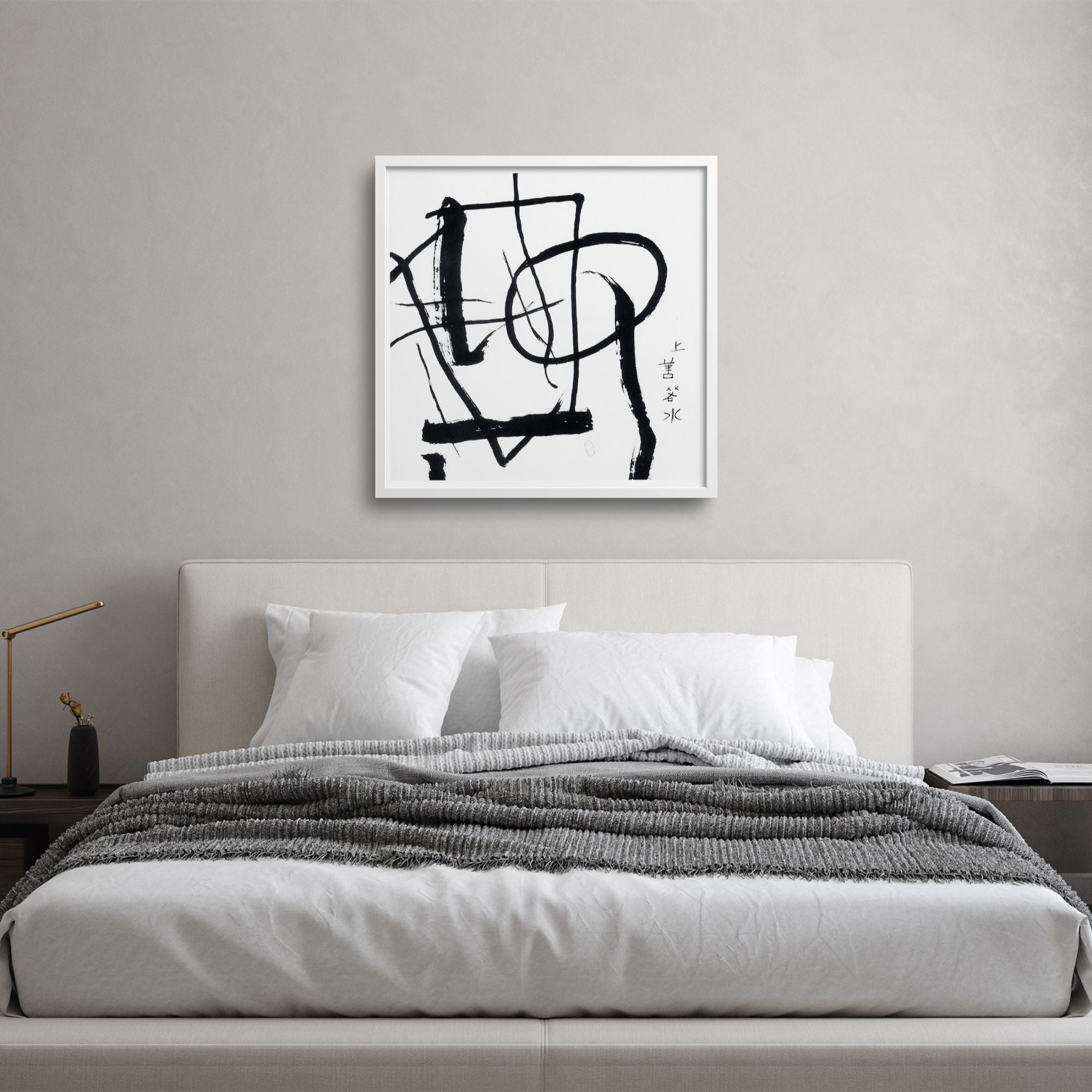 Abstract calligraphy over a japanese style bed in a minimalist bedroom