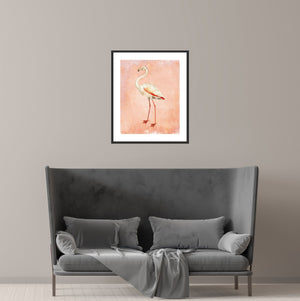 Pink flamingo art print over a couch in a minimalist living room.