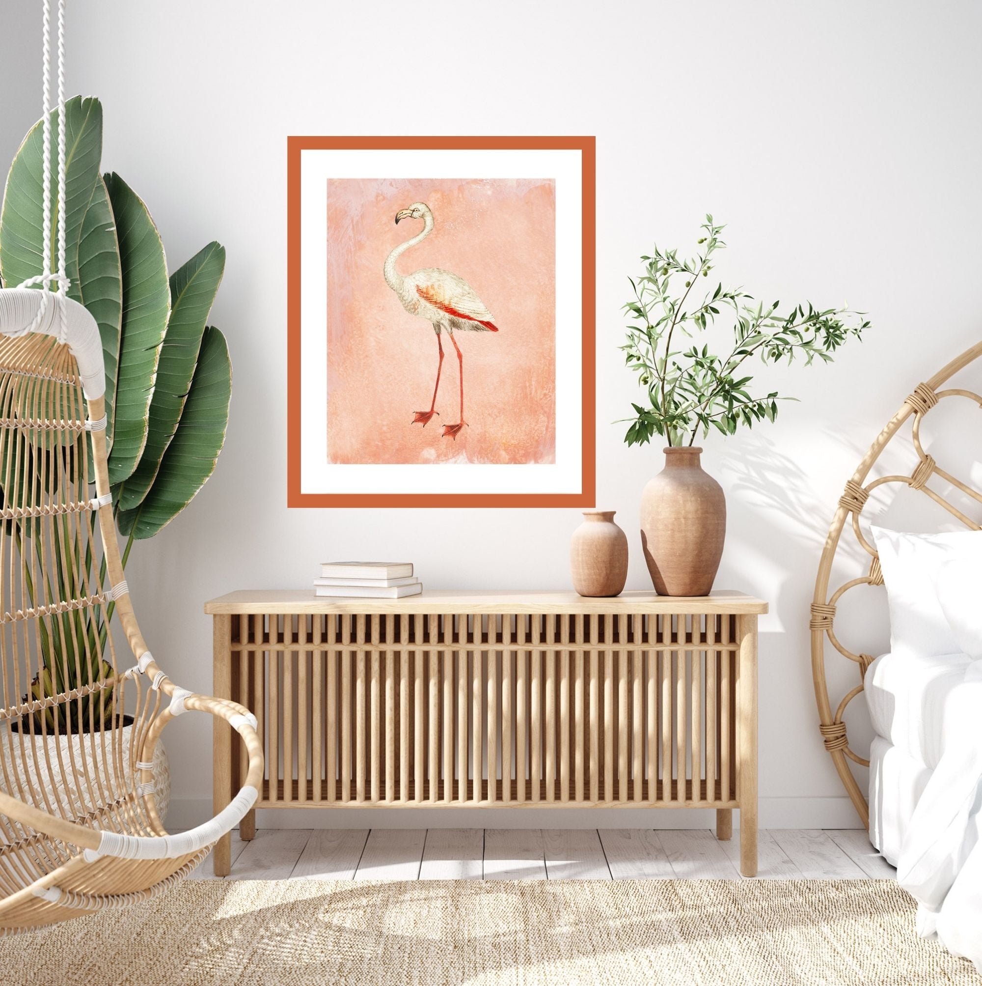 Framed pink flamingo art print in a boho bedroom.