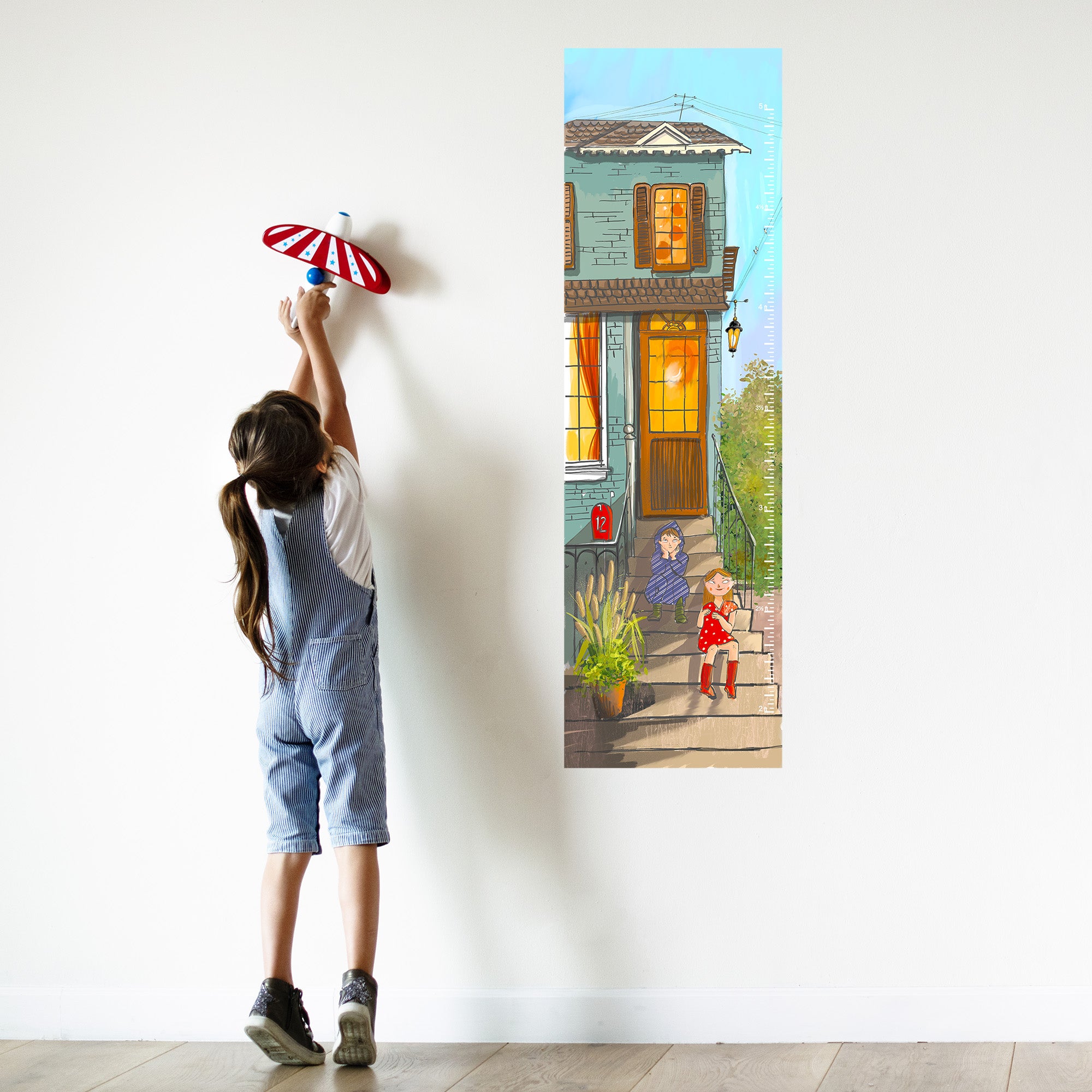 Measuring height with a canvas growth chart for kids.