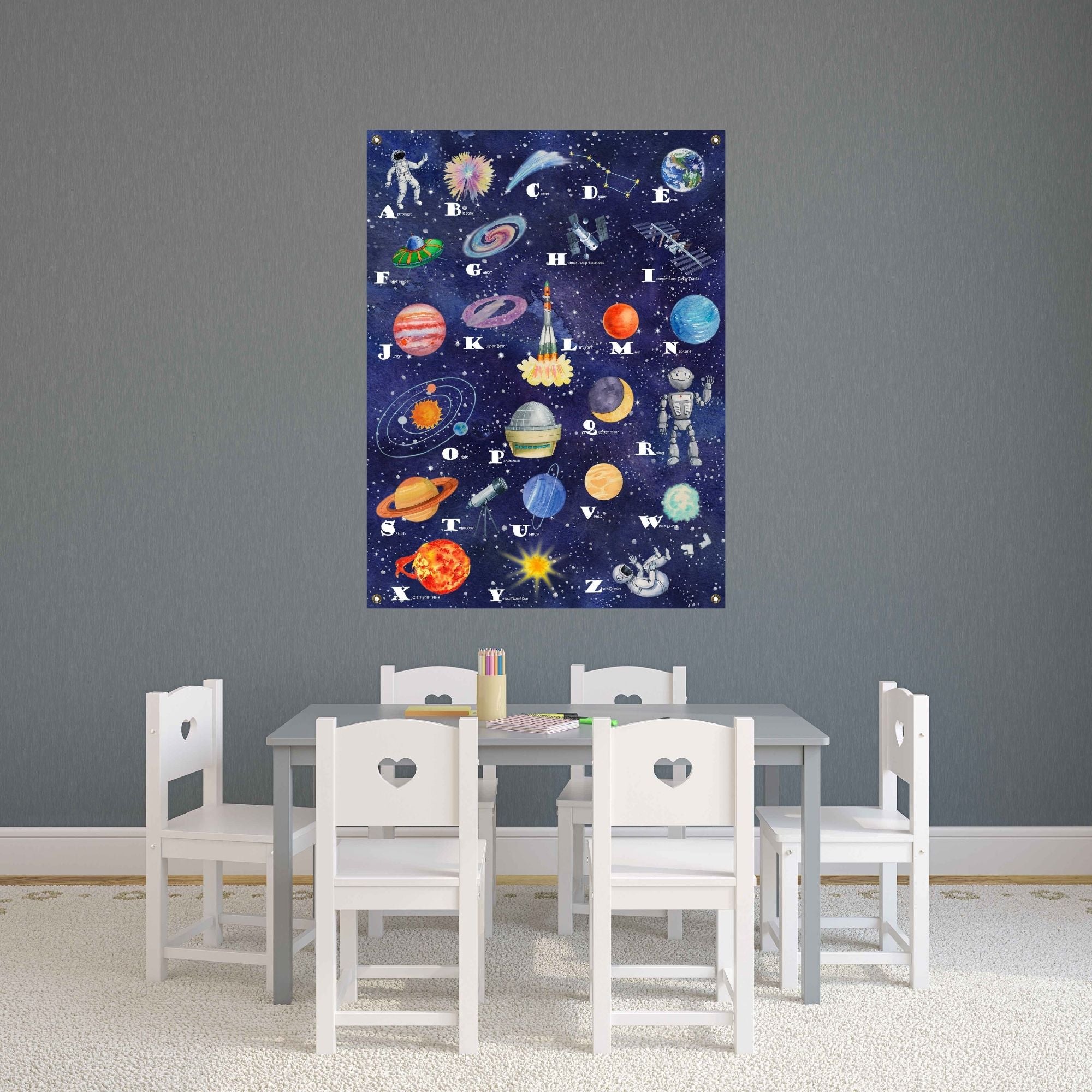 Space alphabet canvas poster with brass grommets in a child's playroom.
