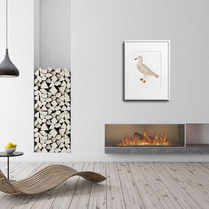 Gull print over a fireplace in a modern, minimalist interior