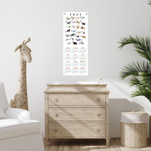 Animal alphabet calendar over a child's dresser.
