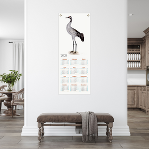 Rudbeck crane 2023 calendar on a white apartment wall.