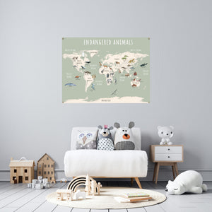 Green endangered animals world map poster hanging over a child's chair.