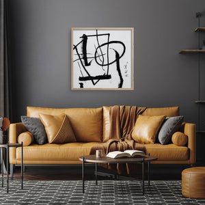 Abstract art print over a leather sofa in a grey room