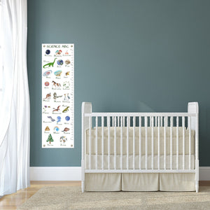 Baby nursery with canvas growth chart next to crib