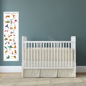 Canvas chart for measuring a child's height in a baby nursery next to a crib