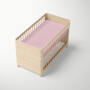 Pink Shibori fitted crib sheet for baby nursery.