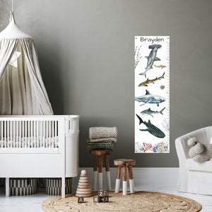 Personalized shark growth chart in a baby's nursery.