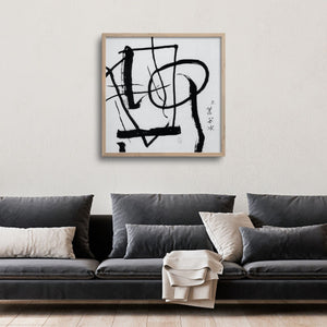 abstract calligraphy over a grey Japandi sofa in a living room