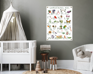 Canvas gardening poster on canvas with brass grommets in a baby's nursery.