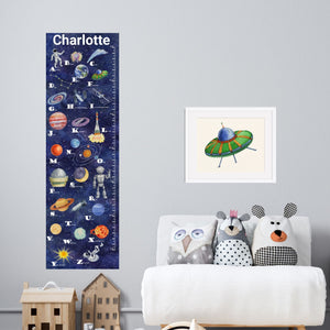 personalized space alphabet growth chart in a child's playroom